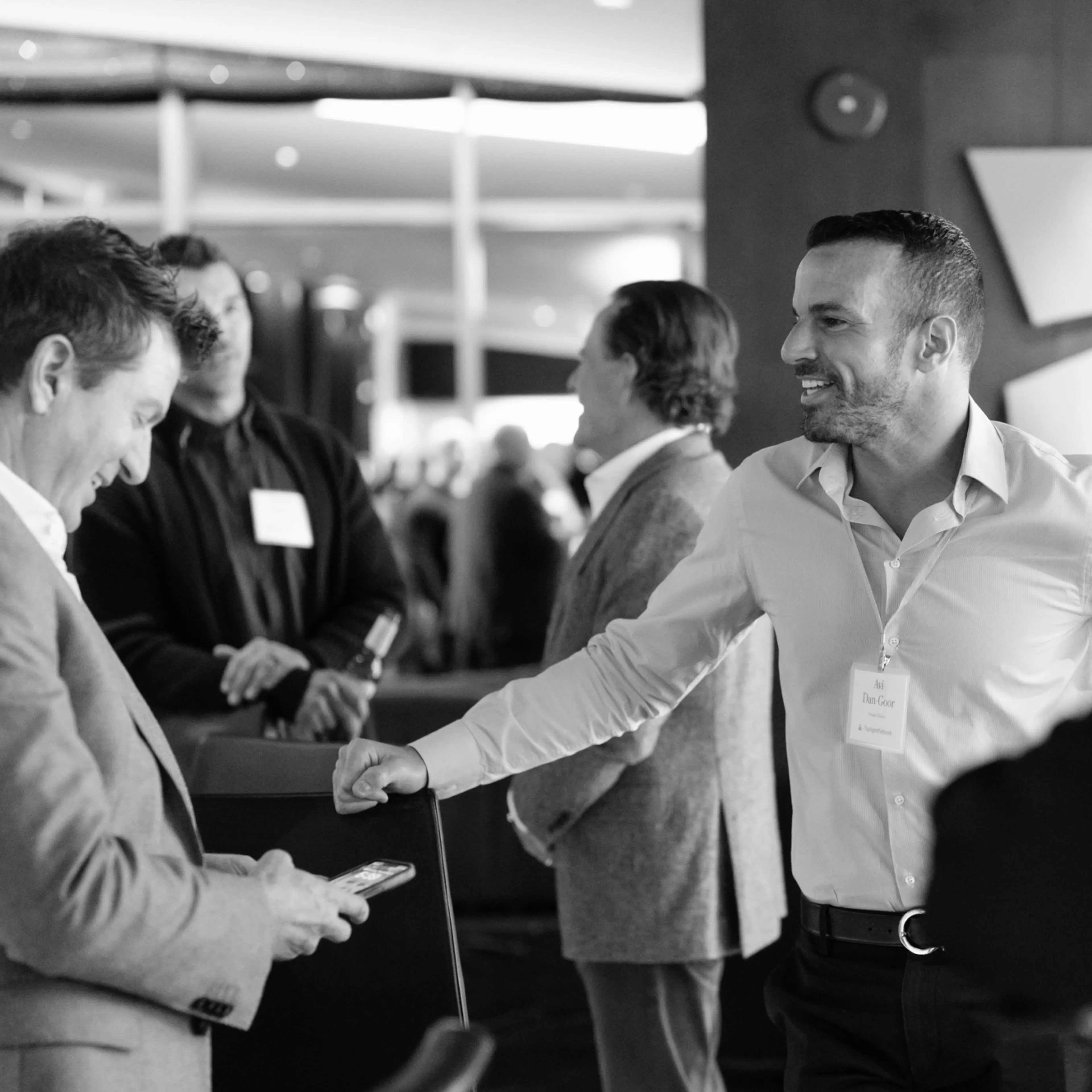 Black and white photo of people conducting sales conversation